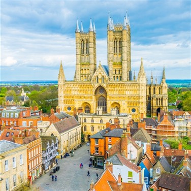 Aerial photo of striking Lincoln Cathedral with the Linconshire countryside in the distance